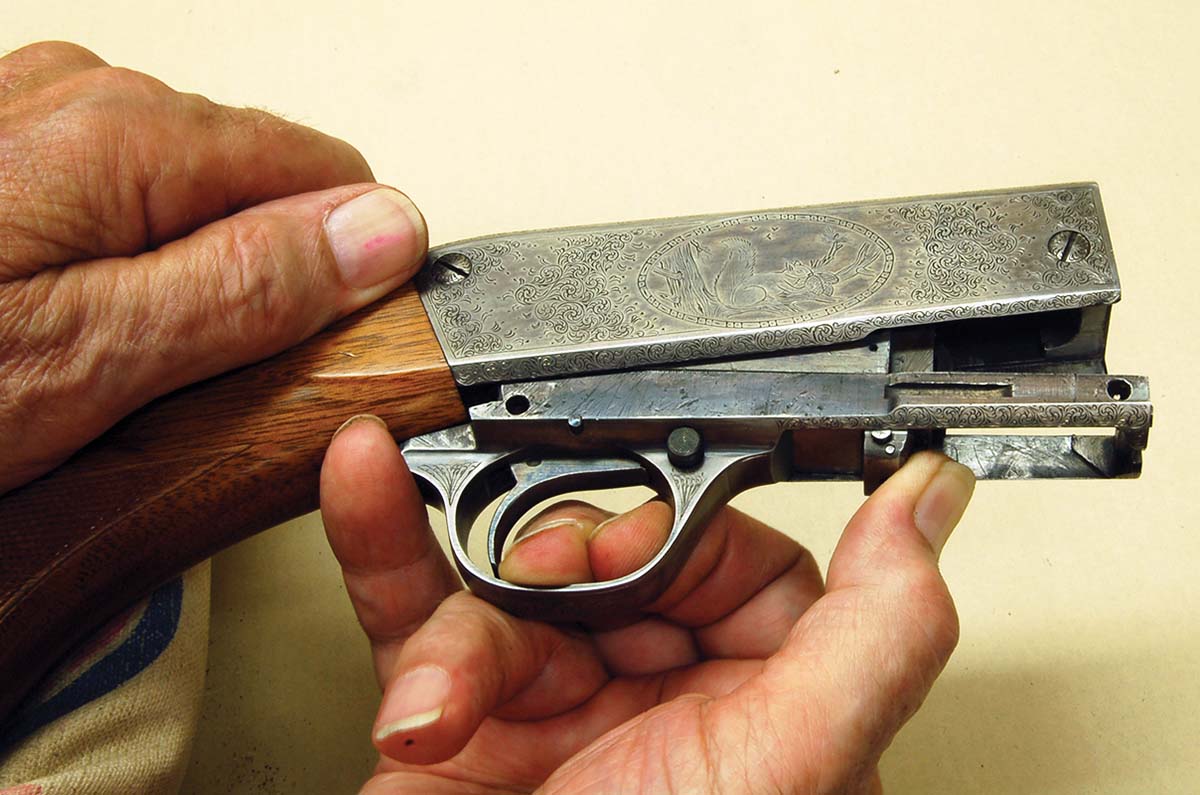 The breechblock is removed by first removing the barrel, then pushing forward and upward as shown.